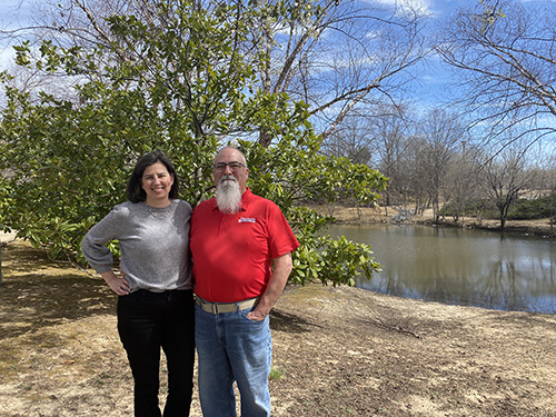 Rich standing next to Katie Pomeroy near the river