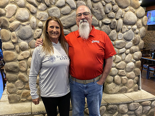 Rich standing with Erin Grampp in front of a rock wall